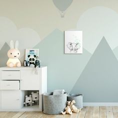 a child's room with mountains painted on the wall