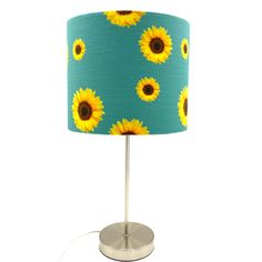 a blue lamp with yellow sunflowers on it