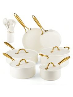 white and gold cookware set with golden handles on the bottom, in front of a white background