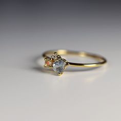 "This beautiful cluster ring was made of 14k gold band, 14k gold prong settings. It's perfect as engagement ring or statement piece. DETAILS ABOUT THE RING, MATERIAL AND STONES * 14k 1.3mm solid gold band and prongs. * 3.5mm round shape aquamarine * 2mm round cut opal * 1.5mm round brilliant cut diamond is 0.02ct * Birthstones : March, April, October This ring was hand crafted in Melt'm Jewelry Studio in California. ------------------------------------ GIFT WRAPPING My regular package is organza Stone Ring Design, Small Diamond Rings, Multi Gemstone Ring, Diamond Rings Design, Ring Settings, Solid Gold Band, Engagement Rings Opal, Jewelry Studio, Stone Engagement Rings