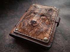 a brown leather wallet with a dog's face on it