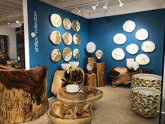 a room filled with lots of different types of wooden furniture and plates on the wall