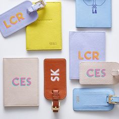 several different colored luggage tags with name tags on them