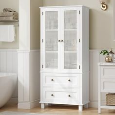 a white cabinet in a bathroom next to a tub