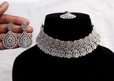 * SIlver choker necklace Set with earrings Tikka as shown in the pic. * Studded with crystals and rhinestones. * One of a Kind. *No.1- Silver *Necklace Width- 1.2 inches * Earrings Length: 1.9 inches(included drops) *Earrings Breadth- 1.1 inches Traditional Silver Choker For Formal Occasions, Traditional Silver Formal Choker, Silver Metal Choker Jewelry Sets, Silver Bridal Choker Necklace, Silver Bridal Necklace With Hand-set Metal, Silver Bridal Choker For Formal Occasion, Silver Bridal Choker Necklace As A Gift, Silver Bridal Choker Necklace Gift, Silver Choker Jewelry Sets As Gift