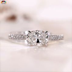 an oval diamond ring with pave set shoulders