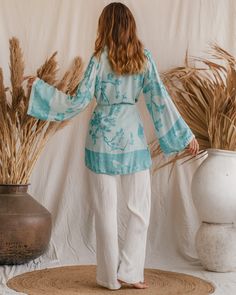 Feel the softness of summer with our Bohemian Breeze Modal Kimono! This sustainable style stunner boasts organic fabrics and a luxurious look that's perfect for sunny days. With an endless sunset color, you'll be radiating every day! Spring V-neck Tunic For Loungewear, Chic Long Sleeve Kimono For Loungewear, Elegant Long Sleeve Relaxed Fit Kimono, Spring Bohemian Blouse For Loungewear, Bohemian Tunic For Daywear With Relaxed Fit, Bohemian Tunic With Relaxed Fit For Daywear, Elegant Relaxed Fit Sleepwear For Spring, Elegant Long Sleeve Sleepwear For Vacation, Chic Flowy Long Sleeve Kimono