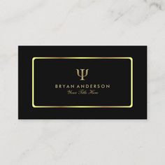 a black and gold business card with an elegant monogrammed logo on the front