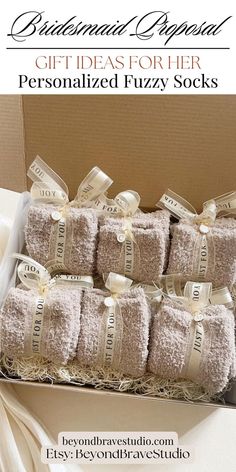 a box filled with lots of white towels and tied in ribbon on top of a table