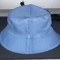 Nwt! ******Only Have The Blue Left****** Quantity: 1 White, 1 Blue Logo At The Crown $55 Each Tailing The Resurgence Of ‘90s Styling This Season Is The Return Of The Bucket Hat, With Calvin Klein Delivering A Refined (Solid Side) 80% Rayon, 20% Linen (Print Side) 100% Polyester Hand Wash Cold Only Before You Place An Order With Me, Please Message Me To Let Me Know Which Color You Want **Please Look At The Pictures Closely And Make Sure It’s What You Want** All Sales Are Final! No Returns Thank Y Blue Cotton Bucket Hat With Flat Brim, Blue Cotton Bucket Hat For Spring, Trendy Blue Flat Brim Bucket Hat, Casual Blue Adjustable Bucket Hat, Light Blue Casual Bucket Hat For Beach, Spring Blue Cotton Bucket Hat, Casual Blue Bucket Hat, Casual Light Blue Bucket Hat For The Beach, Casual Light Blue Bucket Hat For Beach