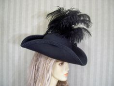 "Beautiful black one of a kind woolen blend pirate/tricorn hat with black braided trim, black flared ostrich feathers, black cocarde with jewel accent.. This hat is about 22 1/2\" for the inside circumference. If this is to big for you then let me know and I can include a hat sizer in your package. I ship Priority mail. I ship many times a week. If you need your item quicker let me know your zip code and I can figure shipping rates for you. Please let me know if you have any questions I accept P Black Brimmed Hat For Themed Events, Black Pirate Costume Accessories For Themed Events, Pirate-themed Black Costume Accessories, Black Felt Hat For Halloween Costume, Black Brimmed Hat With Feather Trim, Black Pirate Costume Hat With Curved Brim, Black Brimmed Costume Hat For Themed Events, Adjustable Black Pirate Costume Hat, Black Curved Brim Hat For Themed Events