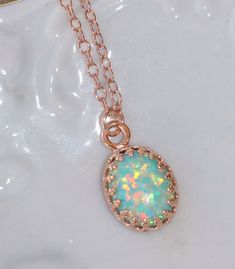 "A lovely necklace made using 14K rose gold filled components and a white opal. The opal is oval in shape and has flashes of pinks, greens, blues and so much more with every turn of the stone! It is my favorite color opal and is a lovely shade of mint green. It's been hand-set into a premium 14K rose gold plated brass crown setting. The pendant hangs from 14k rose gold filled chain. Necklace closes with a gold filled clasp. Opal measures 10mm long (just shy of 1/2\"). Please choose desired chain Delicate Rose Gold Oval Pendant Jewelry, 14k Rose Gold Necklace, Rose Gold Gemstone Oval Pendant Jewelry, Rose Gold Oval Pendant Jewelry With Gemstone, 14k Rose Gold Necklaces For Gifts, 14k Rose Gold Pendant Jewelry Gift, 14k Rose Gold Necklace For Gift, 14k Rose Gold Oval Jewelry, Gift Rose Gold Necklace In 14k Rose Gold