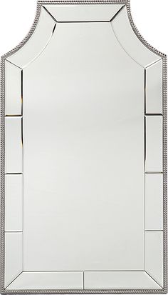 a mirror that is sitting on top of a white surface with silver trimmings