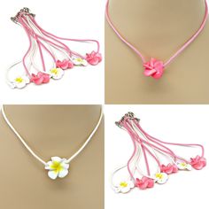 four different necklaces with flowers attached to the neck and two are pink, one is white