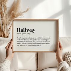 someone holding up a framed sign that says halfway