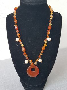 I only make one-offs!! Beautiful, handmade necklace with carnelian and cultured pearls, the highlight is the round carnelian pendant. Carnelian promotes courage, energy and a good mood. Physically, it should have a stimulating effect on the metabolism and circulation. Length: appr.  46 cm This article is finished and will be shipped within 1 working day. All items will be sent to you via a tracked or signed for delivery service. However, shipping times may vary as everything is shipped from Spai Unique Handmade Orange Necklaces, Handmade Unique Orange Necklaces, Bohemian Agate Round Necklaces, Orange Beaded Amulet Necklace, Bohemian Round Agate Necklaces, Handmade Adjustable Orange Necklace, Adjustable Handmade Orange Necklaces, Bohemian Orange Agate Jewelry, Round Carnelian Beaded Necklaces For Gifts