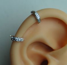 "Textured Pierced Ear-cuff / Helix Cuff Earring / Floral Sterling silver cuff /Small ear cuff / Sterling ear cuff / Scalloped ear cuff / 2 ear cuff so you can wear it anywhere you like.   I can do this shiny or darken it. These are handmade by me and are slightly different sizes. The design is textured with a hint of flowers.  This is a great earring for a man or woman. Measurements- Conch 10mm (3/8\") ID or lobe earrings 1/2\" This listing is for 2 earrings.        Helix 7mm (1/4\") ID   The po White Gold Metal Cartilage Earrings, Silver Clip-on Metal Cartilage Earrings, Elegant Silver Internally Threaded Hoop Earrings, Adjustable Silver Single Clip-on Earring, Adjustable Silver Clip-on Cartilage Earrings, Silver Hypoallergenic Metal Ear Cuff, Hypoallergenic Silver Metal Ear Cuff, Silver Clip-on Cartilage Earrings As Gift, Silver Clip-on Cartilage Earrings For Gift