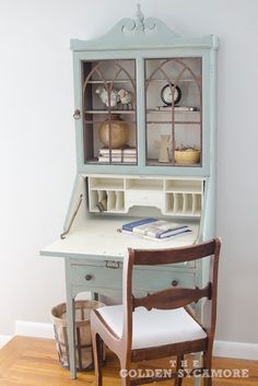 a desk with a hutch and chair next to it on top of a hard wood floor