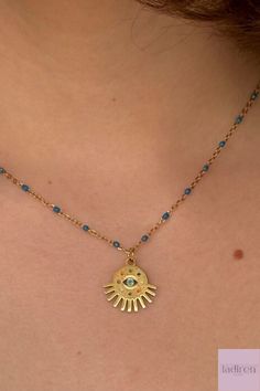 Enhance your style and ward off negativity with our exquisite Gold Evil Eye Pendant Necklace. Featuring a captivating blue beaded chain, this protective amulet jewelry adds a touch of elegance to any outfit. It's the perfect gift for her, offering both style and protection. Adjustable for a perfect fit, this chic necklace makes a thoughtful Mother's Day gift. Amulet Jewelry, Protective Amulet, Eye Pendant Necklace, Chic Necklace, Eye Pendant, Evil Eye Pendant, Perfect Gift For Her, Beaded Chain, Mother's Day Gift