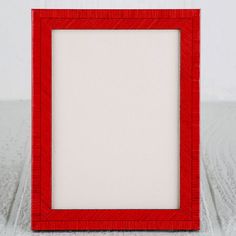 a red frame sitting on top of a white table