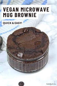 a chocolate cake sitting on top of a counter next to a measuring cup and spoon