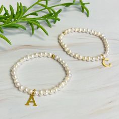 Adorn your wrist with a stylish Freshwater Pearl Initial Charm Bracelet. Featuring freshwater pearls and a clean font initial charm, this bracelet provides both timeless elegance and personalization.It makes the perfect gift for yourself or your loved ones and is suitable for everyday wear or special occasions. Stack it with other bracelets for a stunning layered look.Dimensions: approximately 6.5" before stretchGenuine freshwater pearls18k gold plated stainless steel initial charm with water and tarnish resistantEthically sourcedLead and Nickel freeMade In: ChinaMaterial Composition: 18k gold plated stainless steel, freshwater pearls Clean Font, Clean Fonts, Initial Charm Bracelet, Hair Setting, Pearl Collection, Moissanite Jewelry, Initial Charm, Pearl Color, Fresh Water