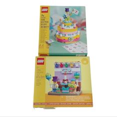 two legos are sitting on top of each other in front of a box with an image of a birthday cake