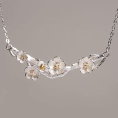 Embrace the timeless elegance of nature with our Plum Blossom Necklace, a stunning piece that captures the delicate beauty of the plum blossom in sterling silver with gold-plated accents. The plum blossom, revered for its resilience and grace, symbolizes strength, perseverance, and the promise of renewal. Each petal is intricately crafted to reflect the flower's natural charm, set on a beautifully detailed branch that wraps gracefully around your neck. Whether worn alone or paired with matching Blossom Flower Jewelry For Spring, Elegant Blossom-colored Spring Jewelry, Elegant Spring Blossom Colored Jewelry, Spring Blossom Jewelry With Flower Decoration, Spring Blossom-colored Flower Decorated Jewelry, Elegant Flower Charm Necklace For Spring, Elegant Spring Necklace With Flower Charm, Blossom Flower Necklaces For Wedding, Delicate Blossom Color Necklaces