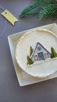 a cake decorated with a house and trees