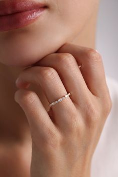 a woman's hand with a diamond ring on her finger