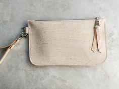 This dreamy white wristlet is giving us all the fashionista feels....how about you? A chic and eco-friendly wristlet made from eco-friendly cork leather is perfect for carrying your cash, cards and phone. Its useful keyring loop for attaching keys make for easier finding in your purse and a detachable wrist strap give you the option to use as a zip pouch inside your bag to keep small essentials organized. SMALL: 7 inches wide, 4.5 inches high LARGE: 8.5 inches wide, 5 inches high See more wristlet bundles and cork leather accessories here:  https://www.etsy.com/shop/hookandrope/?section_id=34318397 White Clutch Bag, Wristlet Pouch, White Clutch, Wristlet Purse, Leather Clutch Bags, Makeup Bags, Wristlet Wallet, Zip Wallet, Leather Wristlet