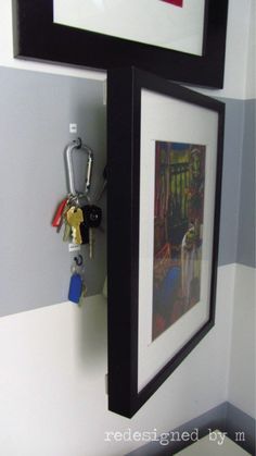 there is a key chain hanging on the wall next to a framed photo and two keys