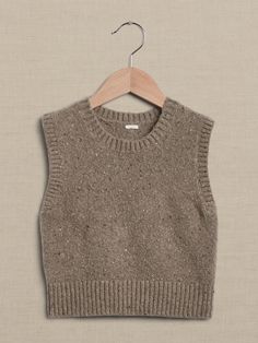 a sweater hanging on a wooden hanger