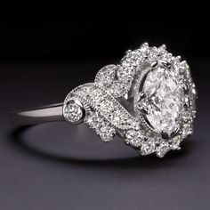 an oval shaped diamond ring with two rows of diamonds around the band on top of it