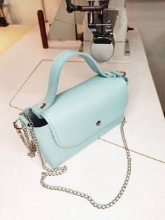 Mini handbag, baby blue leather mini bag, phone bag, miniature handbag, tiny leather bag. This mini handbag is in line with the latest trends. Made of baby blue natural leather, it has no lining or pockets and is finished in raw leather. It fastens with a snap closure. The sides are decorated with three silver-colored rivets, giving it a rockier feel. Additionally, it comes with a chain, allowing you to carry the handbag on your shoulder. Great as a gift for her. Dimensions: Height: 10 cm/ 3 inches Width: 18 cm/ 7 inches Bottom: 7 cm/ 2 inches Total length of the chain: 120 cm/ 47 inches Remember that each of our handbags is hand-sewn in our workshop, offering you the possibility of personalization. You can start by changing the color of the leather or material, add or remove elements (suc Blue Handheld Box Bag For Everyday, Everyday Blue Handheld Box Bag, Everyday Blue Mobile Phone Box Bag, Trendy Blue Phone Bag As Gift, Trendy Blue Phone Bag For Everyday Use, Trendy Blue Phone Bag For Gift, Trendy Blue Leather Box Bag, Trendy Blue Everyday Phone Bag, Blue Satchel Box Bag For Gift