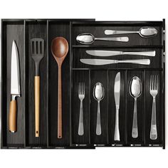 an assortment of utensils and spoons in a wooden box with dividers