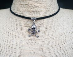 "Skull and Crossbones Necklace Cord Necklace Vegan Choker Pendant Necklace Pirate Choker Black Suede Necklace Unisex Necklace ~ A boho necklace with metal pendant. ~ Black colour cord, 12\" shortest length. ~ Clasp and 2\" extender chain to adjust to you. ~ Made with the utmost care to enjoy it as long as possible. All jewelries are are in stock and ready to be shipped within 1-2 business day from ordering to dispatch. Please note these times increase during Christmas & busy periods. 🌍 SHIPPING Emo Jewelry Necklaces, Halloween Grunge Adjustable Choker, Skull Choker Necklace, Choker Necklace Goth, Skull Choker, Goth Choker Necklaces, Suede Necklace, Goth Choker, Choker Black