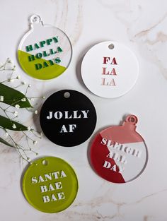 DETAILS: Level up your tree, stockings, or gifts with these personalized funny, unique + modern Christmas ornaments.  Ornament Sayings: "Jolly AF", "Sleigh All Day", "Santa Bae Bae", "Happy Holla Days" "Fa La La" Each tag is 1/8 inches thick acrylic and measure about 3 inches wide by about 3 inches tall.  There are two styles: 1) Circle and 2) Bulb Shape. See details on how to order below. For custom orders or designs message me directly. We love custom orders!! --------------------- WHAT IS INCLUDED IN YOUR ORDER: * ONE ornament with saying * Comes with 6 in red and white yarn for hanging --------------------- HOW TO ORDER (can't wait to work with you * Choose your ornament saying from the dropdown * Choose your ornament style from the dropdown * Choose your quantity  For custom orders or Christmas Ornaments Acrylic, Colorful Christmas Ornaments, Modern Ornaments, Holiday Place Cards, Ornaments Acrylic, Jolly Af, Acrylic Gift, Modern Christmas Ornaments, Stocking Tags