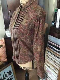 "Vintage 1960's long sleeve blouse. Paisley print in colors of Browns/Rust brown/Olive Drab. Colors are a bit darker than they show in pictures. No makers label. *SCROLL DOWN FOR MEASUREMENTS* CONDITION: No issues noted. No fading to the colors. MEASURES: Bust~34\" Waist~32\" Hips~32\" Sleeve length~22\" Shoulder seam to shoulder seam~13\" Back of collar to bottom~22 1/2\" HOW TO MEASURE: BUST~ Measure loosely around the fullest part of your bust, with the tape straight across and your back, bri Long Sleeve Patterned Blouse With Paisley Print, Fall Paisley Print Tops For Work, Fall Paisley Print Work Tops, Long Sleeve Tops With Paisley Print For Work, Cotton Blouse With Paisley Print For Fall, Vintage Patterned Long Sleeve Tops, Vintage Long Sleeve Blouse With Vintage Print, Fall Vintage Blouse With Vintage Pattern, Vintage Long Sleeve Patterned Tops