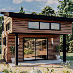 a small wooden building sitting in the middle of a field