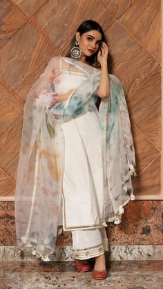 Make an everlasting, eternal impression at any upcoming festive occasion in this white cotton suit set with beautiful multi color dupatta comparising with beautiful gotta lace boarder.The suit set features an overall gotta patti lace work,The multi color organza dupatta comes with an gotta lace border and tassel detailing around the edges. This is a great pick for the festive season! SKU#: 11403157WH Disclaimer: There may be slight difference in actual product color compared to product images. Simple Suit Designs, Suits For Women Indian, डिजाइनर कपड़े, Indian Dresses For Women, Organza Suits, Trendy Outfits Indian, Fancy Sarees Party Wear, Casual Indian Fashion, Traditional Indian Outfits