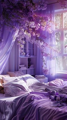 a bed with purple sheets and pillows in front of a large window that has curtains over it