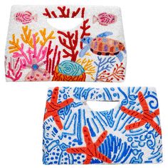 two place mats with sea animals and corals on them, one has an orange starfish