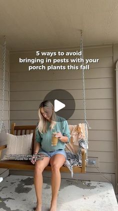 a woman is sitting on a porch swing