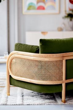 a green couch sitting on top of a white rug