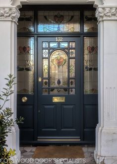 a blue front door with stained glass windows