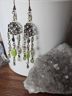 get ready for many compliments with these gorgeous chandelier earrings! They feature stunning glass green beads and mineral beads, brass beads, and findings! Lightweight to keep your ears feeling great! Shipping will not change with multiple earrings, however you must contact me before you pay so I can adjust the price.   I strive to make the happiest of customers!  And I work hard to ensure long lasting quality items! If something is wrong with an item please contact me immediately so I can access and try to work on the best solution!  I appreciate you stopping by to view my items!  I appreciate your business! Handmade Green Crystal Metal Earrings, Green Bohemian Metal Chandelier Earrings, Green Bohemian Chandelier Earrings, Green Metal Bohemian Chandelier Earrings, Nickel Free Green Bohemian Chandelier Earrings, Green Nickel-free Bohemian Chandelier Earrings, Green Bohemian Chandelier Earrings Nickel Free, Handmade Green Metal Chandelier Earrings, Green Metal Beaded Drop Earrings