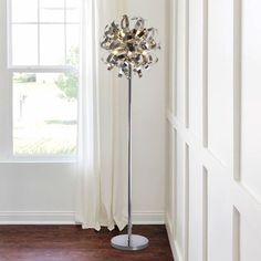 a floor lamp in front of a window