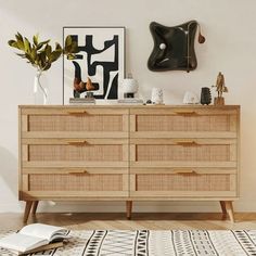 a wooden dresser sitting on top of a hard wood floor next to a white wall