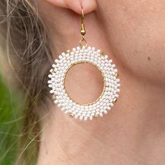 Introducing the Nube Earrings, a delightful blend of whimsy and elegance. Named after the Spanish word for "cloud," these charming earrings feature a gold-colored circle adorned with handwoven white and gold Czech beads. Their classic look effortlessly elevates any outfit, making them perfect for both everyday wear and special occasions. Let the Nube Earrings bring a touch of airy grace and timeless sophistication to your style, and float through your day with a lighthearted elegance that’s simp Spanish Words, Outfit Making, Party In A Box, Craft Shop, Czech Beads, Gift Card Shop, Corporate Gifts, Classic Looks, Color Splash